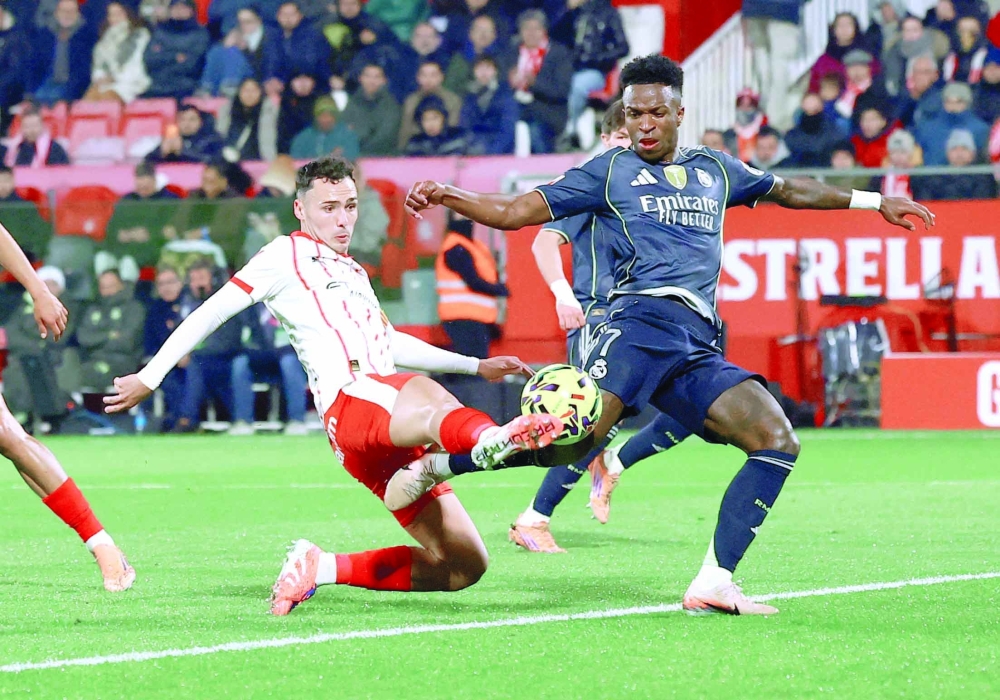 Real Madrid's Vinicius Junior in action with Girona's Arnau Martinez. — Reuters