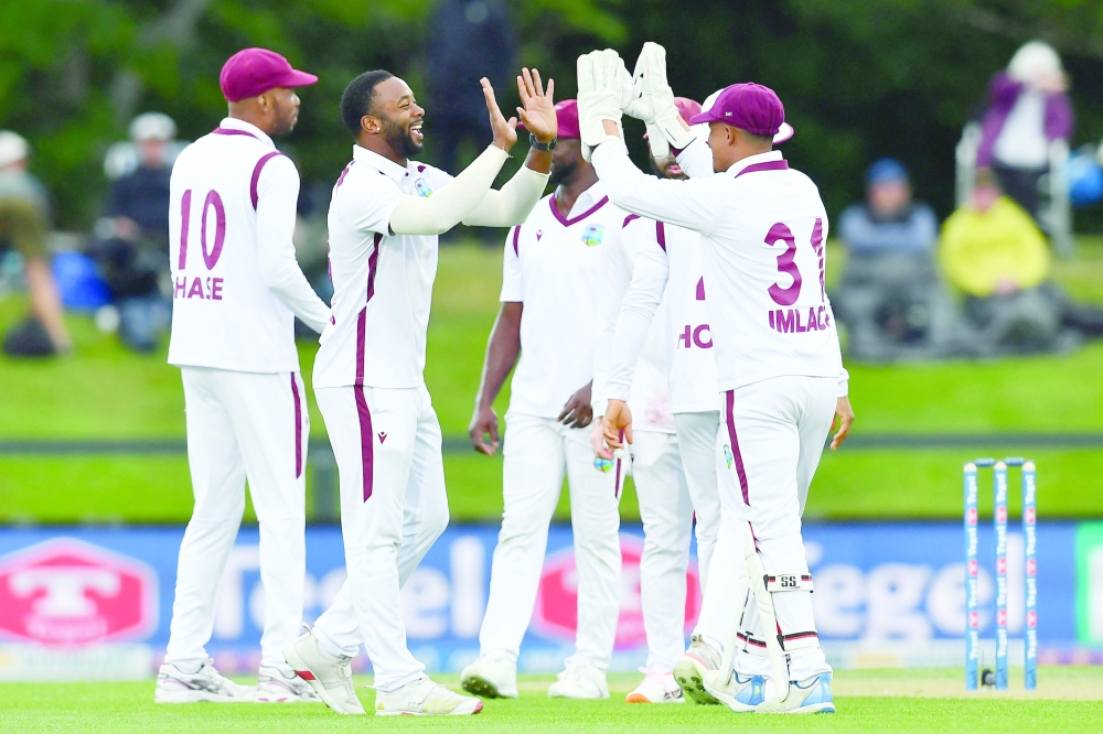 West Indies' Ojay Shields (2nd L) celebrates the wicket of New Zealand's Michael Bracewell with his teammates during day one of the first Test cricket match between New Zealand and West Indies at Hagley Oval in Christchurch on December 2, 2025.  (Photo by Sanka Vidanagama / AFP)
