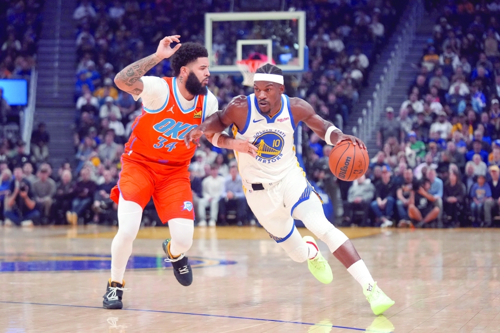 Golden State Warriors forward Jimmy Butler III (10) dribbles the ball next to Oklahoma City Thunder guard Kenrich Williams (34). — Reuters 