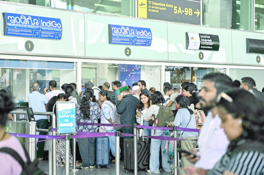 Passengers line up at an IndiGo Airlines kiosk at the Kempegowda International Airport in Bengaluru. - AFP