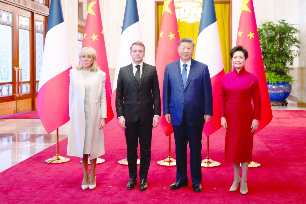 Welcoming ceremony for the French President Macron and Brigitte Macron by China's President Xi Jinping and his wife, in Beijing. - AFP