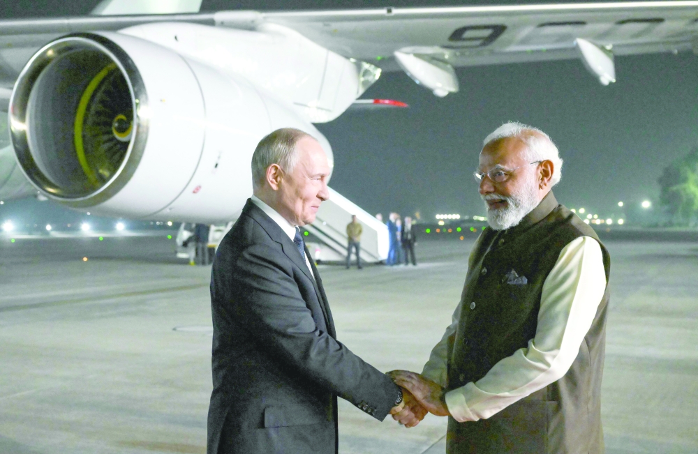 Russia's President Vladimir Putin is welcomed by Indian Prime Minister Narendra Modi in New Delhi. — AFP