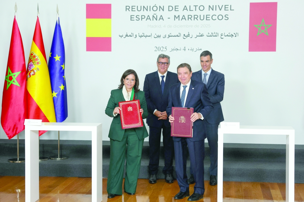Spain's Agriculture Minister Luis Planas and Secretary of State, Ministry of Agriculture, Fisheries and Rural Development, Driouich Zakia (L) during a signing ceremony at the Moncloa Palace in Madrid. - AFP