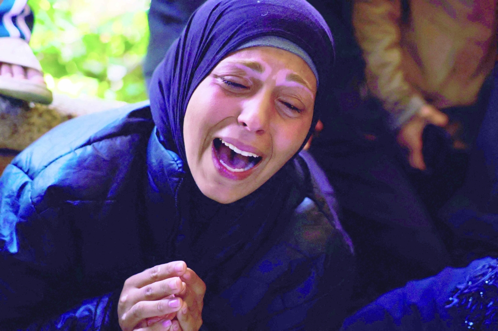 A mourner reacts as she attends with others the funeral of Palestinians killed by an Israeli strike, at Nasser Hospital in Khan Yunis, southern Gaza Strip. - AFP