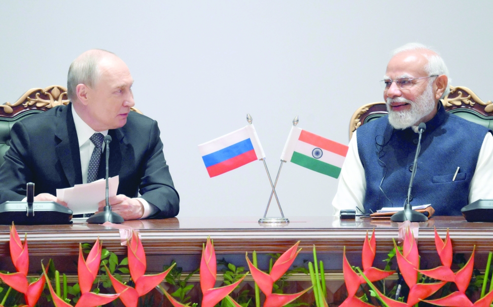 In this pool photograph distributed by the Russian state agency Sputnik, Russia's President Vladimir Putin and India's Prime Minister Narendra Modi attend a plenary session of the India-Russia trade forum in New Delhi on December 5, 2025.  - ***Editor's note : this image is distributed by the Russian state owned agency Sputnik***
 (Photo by Grigory SYSOYEV / POOL / AFP) / ***Editor's note : this image is distributed by the Russian state owned agency Sputnik***