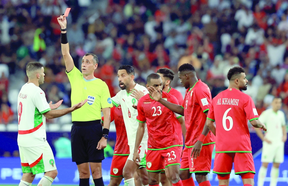 Soccer Football - FIFA Arab Cup - Qatar 2025 - Group B - Oman v Morocco - Education City Stadium, Al Rayyan, Qatar - December 5, 2025 Morocco's Abderrazak Hamdallah is shown a red card by referee Juan Gabriel Benitez REUTERS/Thaier Al-Sudani