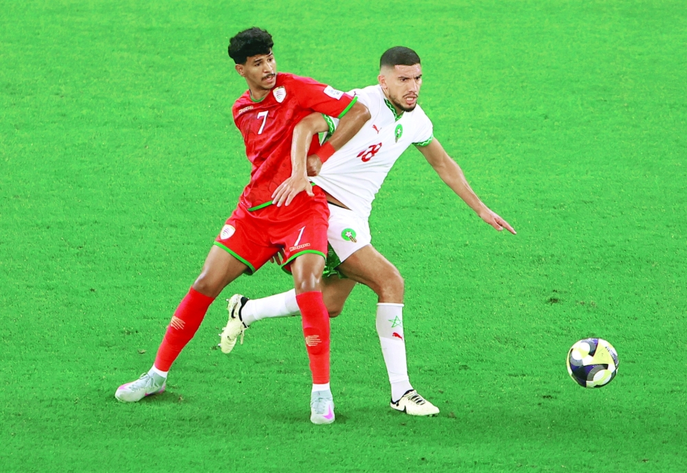 Soccer Football - FIFA Arab Cup - Qatar 2025 - Group B - Oman v Morocco - Education City Stadium, Al Rayyan, Qatar - December 5, 2025 Morocco's Marwane Saadane in action with Oman's Issam Al Sabhi REUTERS/Rula Rouhana