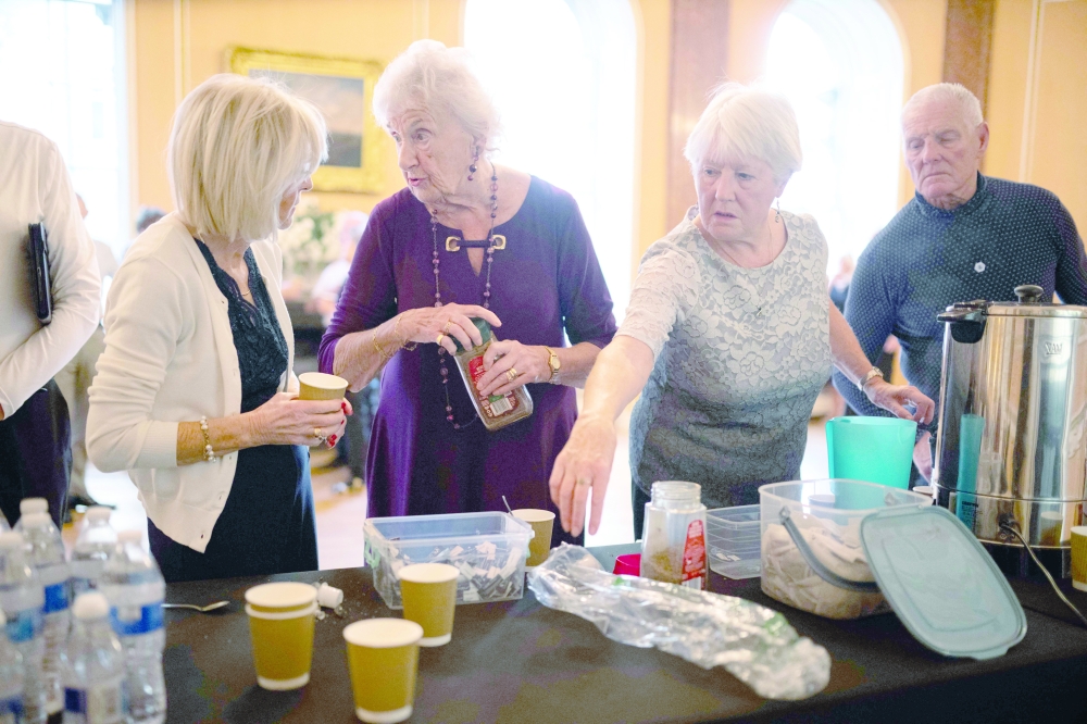 Ballroom dancers chat as they help themselves to tea and coffee in a side room during a Tea Dance, held in the Main Ballroom of Liverpool Town Hall, in Liverpool. — AFP