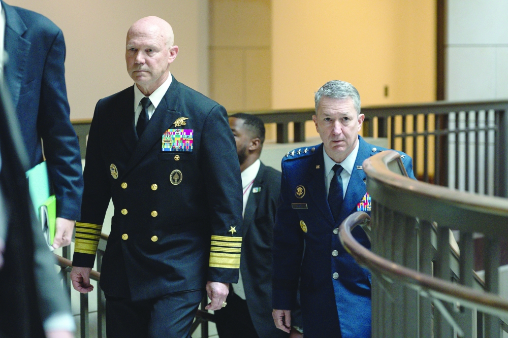 US Navy Admiral Frank “Mitch” Bradley, left, and US Air Force Gen. Dan Caine, the chairman of the Joint Chiefs of Staff, arrive for a closed door classified meeting with lawmakers on Capitol Hill in Washington.