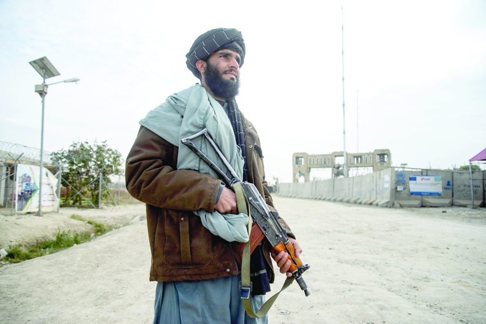 A Taliban security personnel stands guard near the zero point border crossing between Afghanistan and Pakistan. — AFP