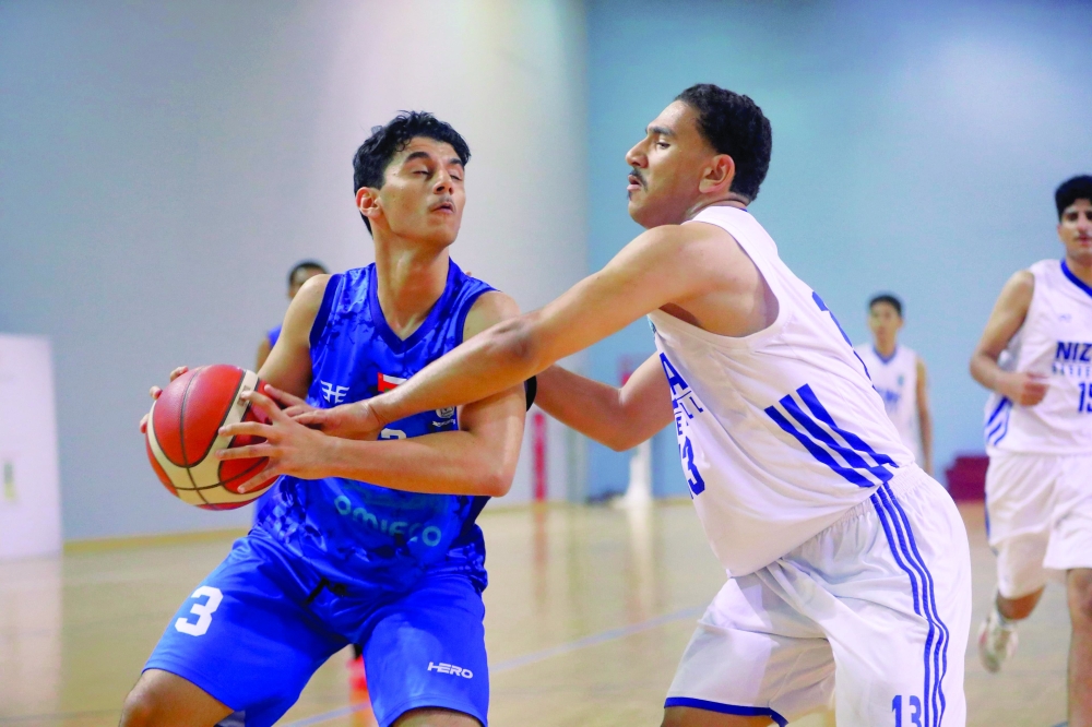 Nizwa and Masirah players fight for the ball. 