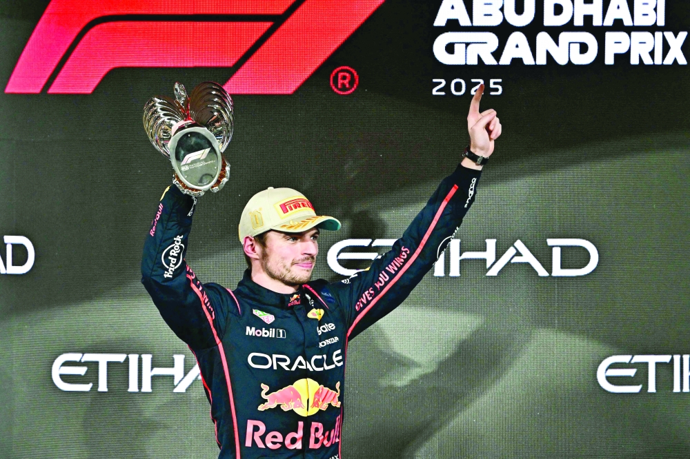 Race winner Red Bull Racing's Dutch driver Max Verstappen celebrates on the podium at the end of the Abu Dhabi Formula One Grand Prix. — AFP 