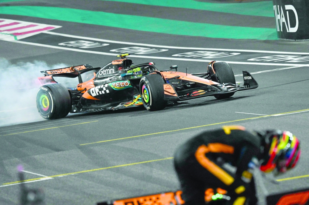McLaren's British driver Lando Norris performs a donut as he celebrates winning the world championship title at the end of the Abu Dhabi Formula One Grand Prix. — AFP 