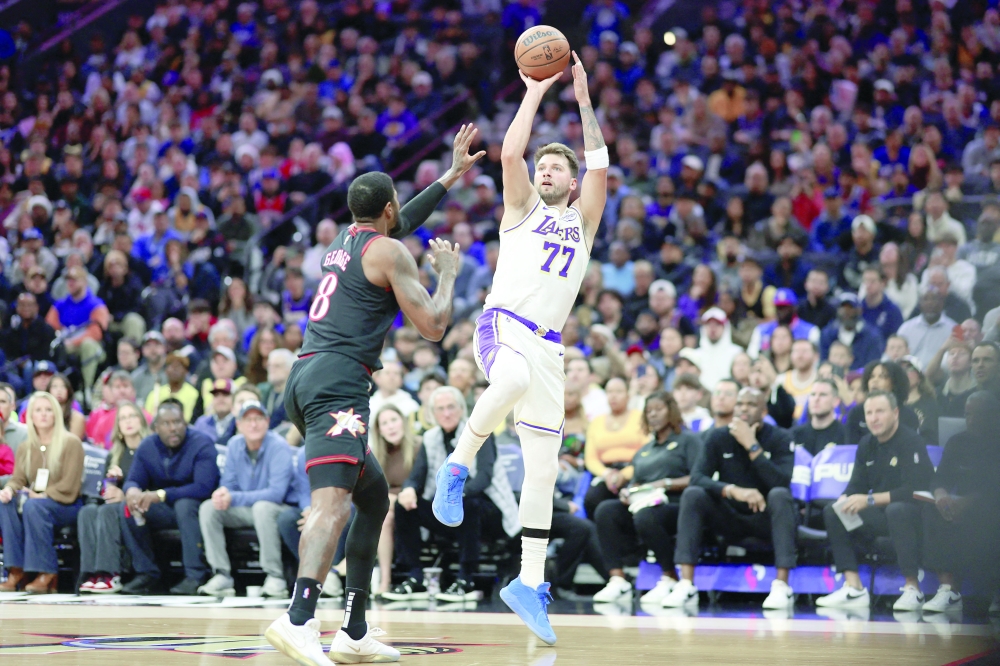 Los Angeles Lakers guard Luka Doncic (77) shoots against Philadelphia 76ers forward Paul George (8). — Reuters