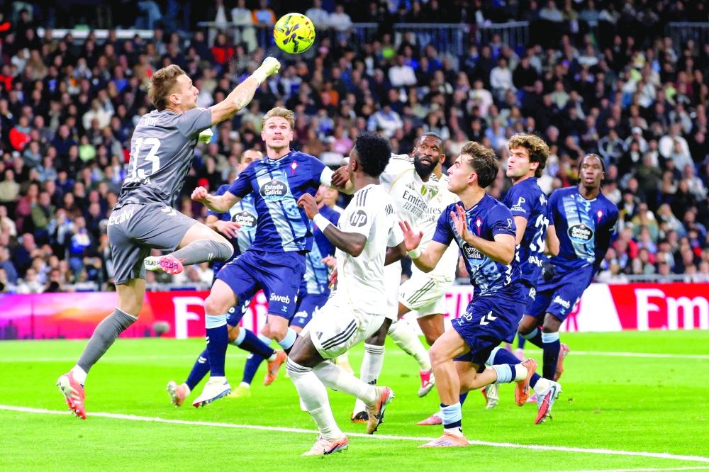 Celta Vigo's Romanian goalkeeper #13 Ionut Andrei Radu (L) hits the ball during the Spanish league football match between Real Madrid CF and RC Celta de Vigo. — AFP