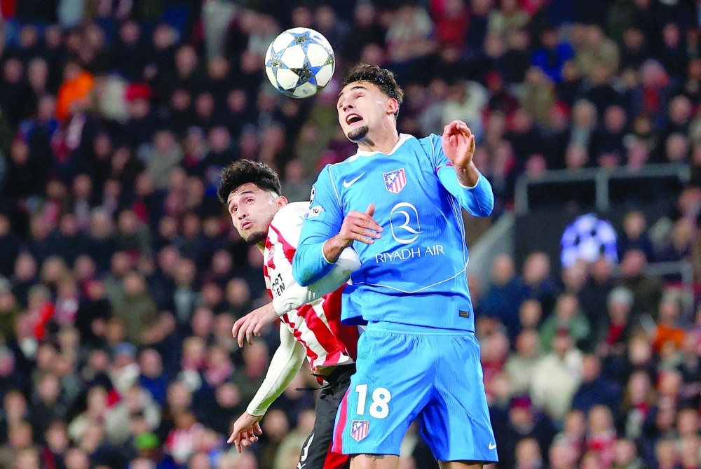 Atletico Madrid's Marc Pubill in action with PSV Eindhoven's Ricardo Pepi. — Reuters