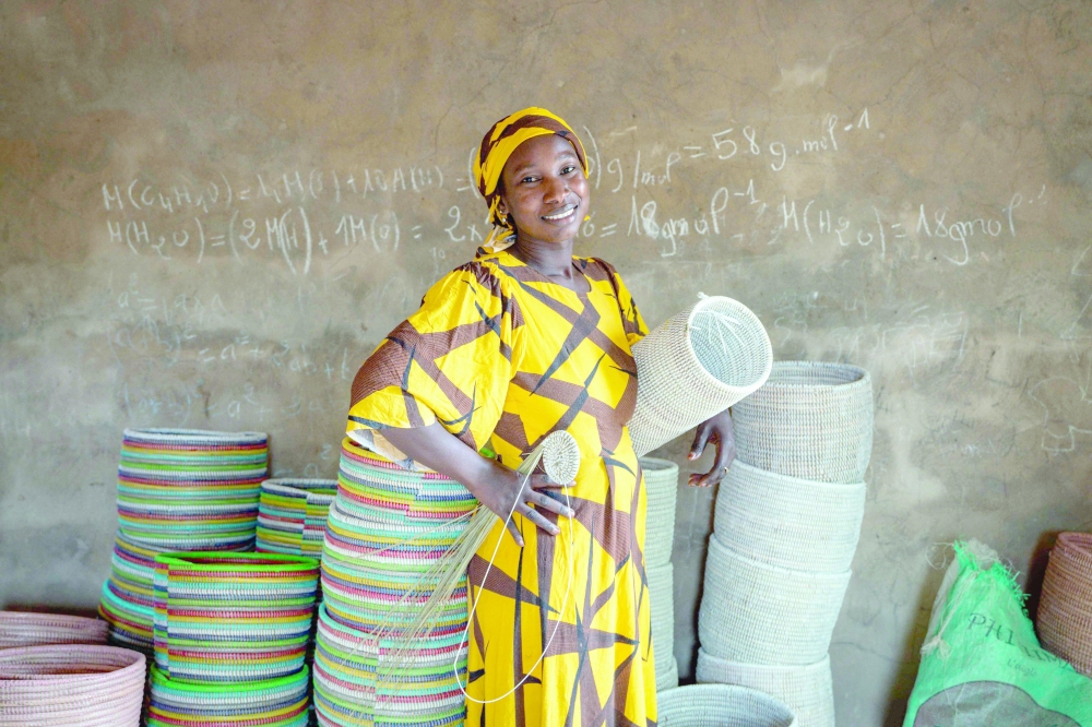 Khady Sene with a Senegalese handicraft basket at her house in Mborine. — AFP  