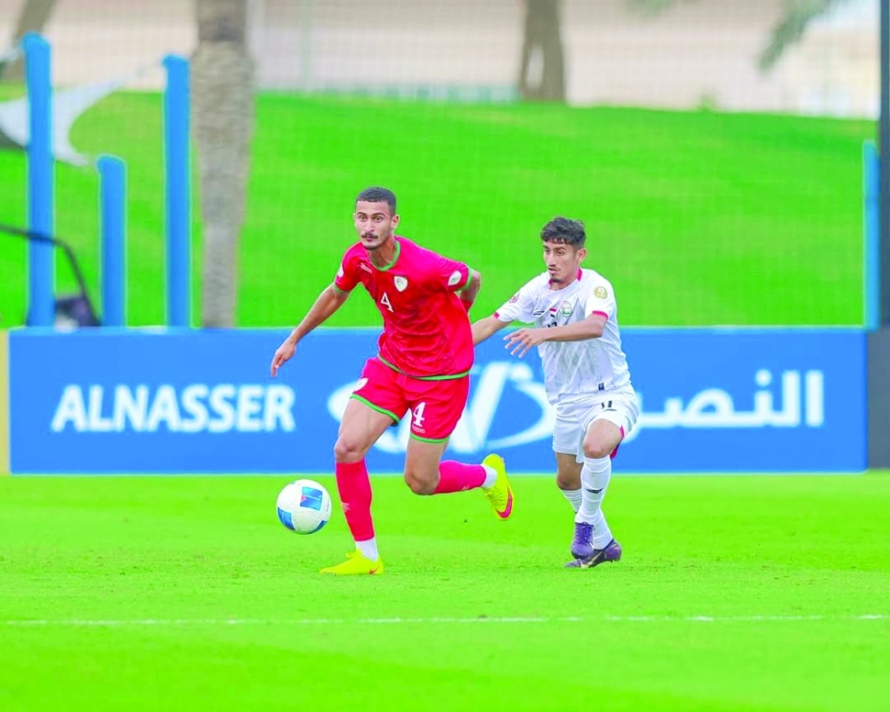 Oman and Yemen players fight for the ball in Doha.
