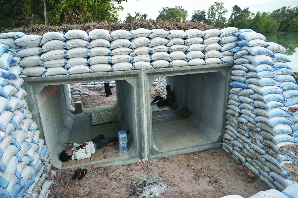 Displaced residents rest in a bunker in Thailand's Surin province amid clashes along the Thai-Cambodia border. - AFP

