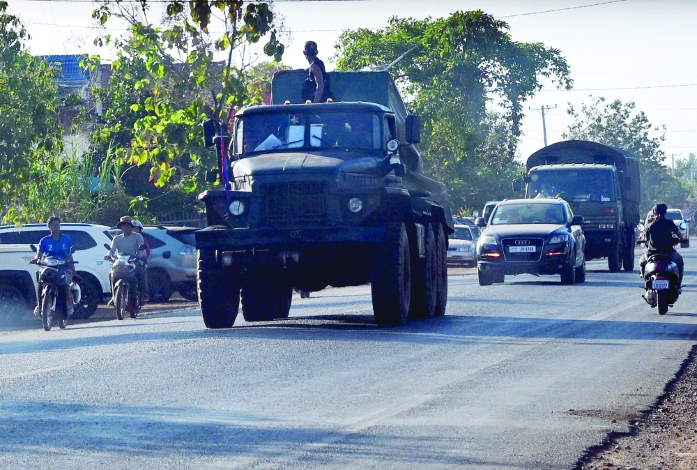 A soldier stands on a multiple rocket launcher B-21 along a street in Siem Reap province during clashes along Cambodia-Thailand border. — AFP