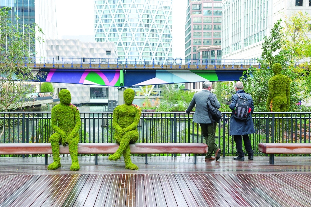 Two men observe the new Eden Dock development in the financial and business district in London, Britain. — Reuters