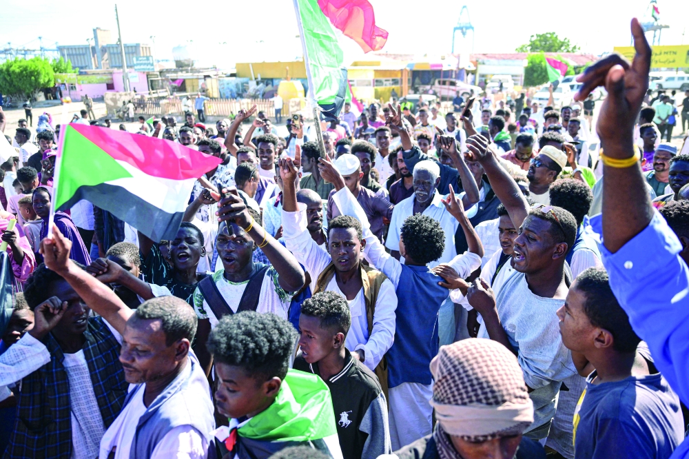 Sudanese take to the streets during a rally in support of the army, Port Sudan. — AFP