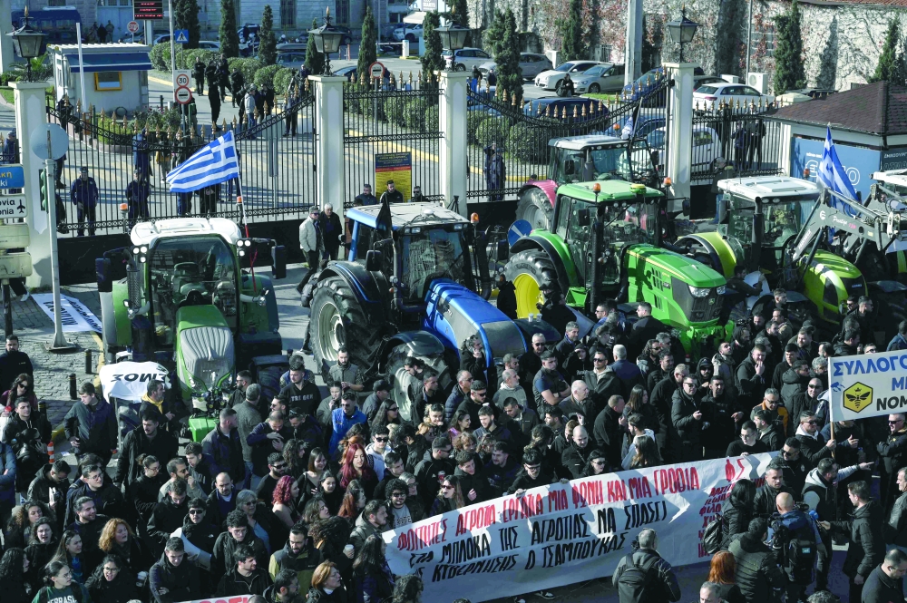Farmers take part in a demonstration as they block with tractors, the port of Thessaloniki on December 12, 2025. Thousands of Greek farmers have since late November 2025 blocked highways, mainly in the centre and north of the country, to demand swifter access to EU subsidies delayed by an ongoing probe into multi-million fraud.