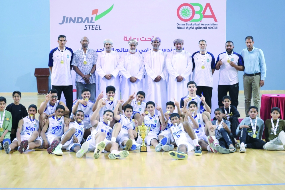 Nizwa players celebrate with the trophy and gold medals. — Moosa al Balushi