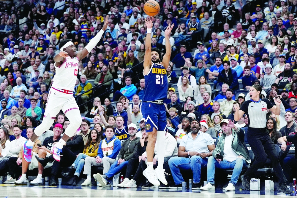 Denver Nuggets guard Jamal Murray (27) releases a three point shot past Houston Rockets guard Aaron Holiday (0). — Imagn Images