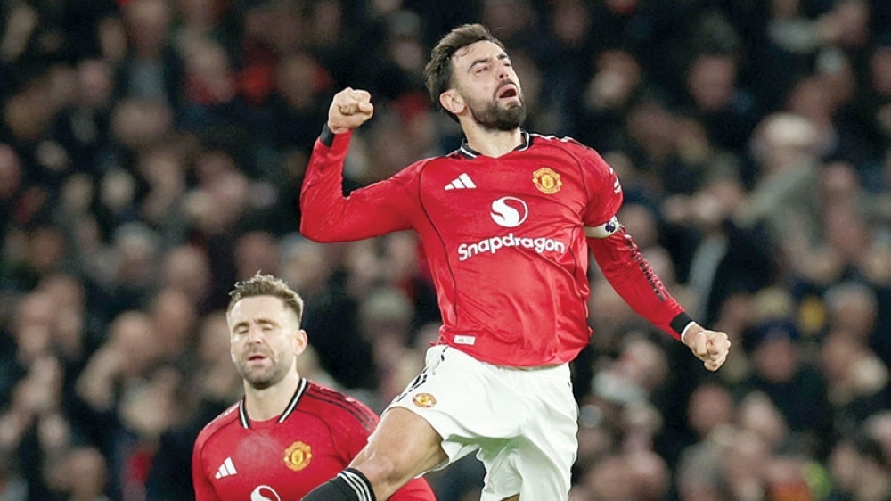 Manchester United's Bruno Fernandes celebrates scoring their third goal with Manchester United's Luke Shaw. — Reuters