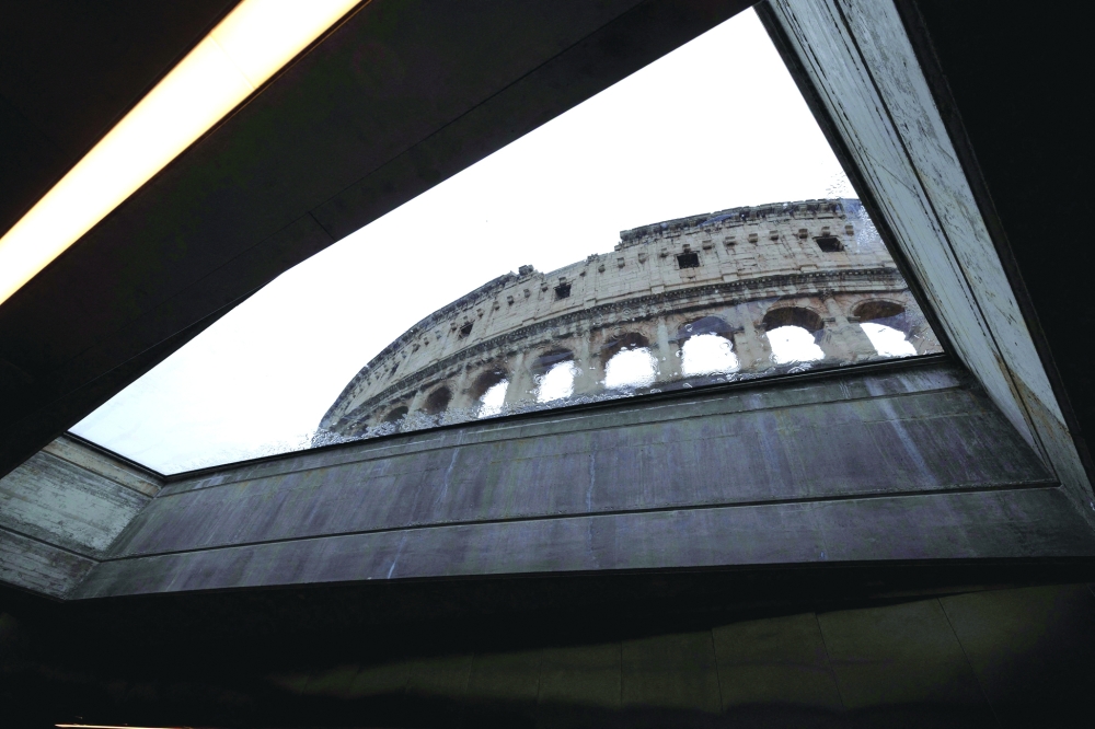 The Colossuem is seen through a window of the new metro line of the Colosseum metro station. — Reuters