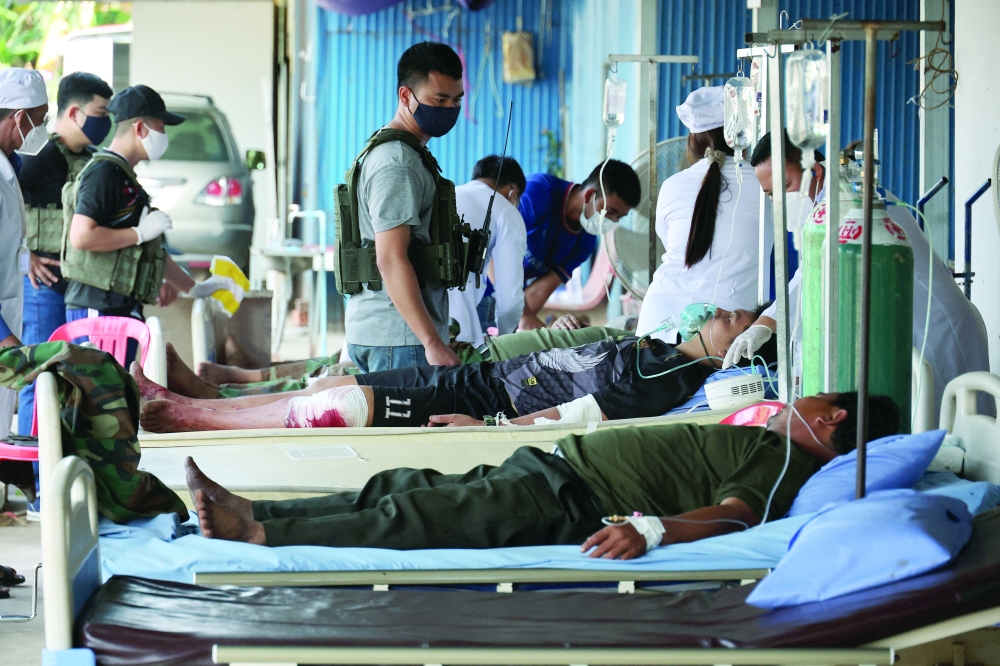 Cambodian soldiers transferred from a frontline lie in hospital beds at Ou Chrov referral hospital. — Reuters
