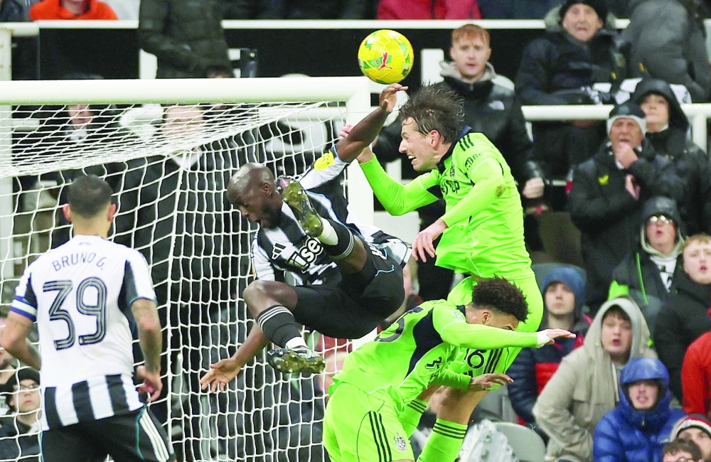 Fulham's Antonee Robinson and Fulham's Sander Berge in action with Newcastle United's Yoane Wissa. — Reuters 