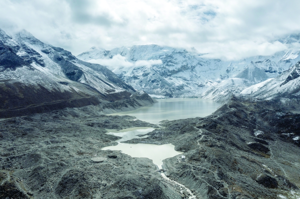 The spillway, foreground, at Imja Lake in Nepal, an attempt to reduce flood hazard, in June 2025. Melting glaciers are still feeding the lake, causing it to grow longer. — NYT photo