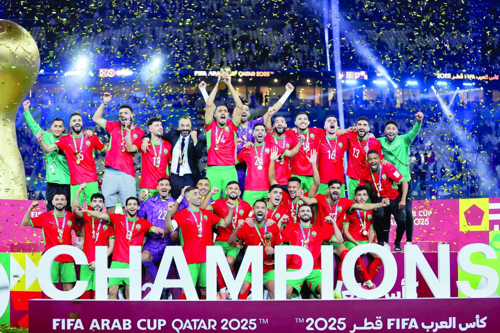 Morroco's players celebrate with the trophy after winning the FIFA Arab Cup 2025 final football match between Jordan and Morocco at the Lusail Stadium  Stadium, in Lusail on December 18, 2025. (Photo by Karim JAAFAR / AFP)
