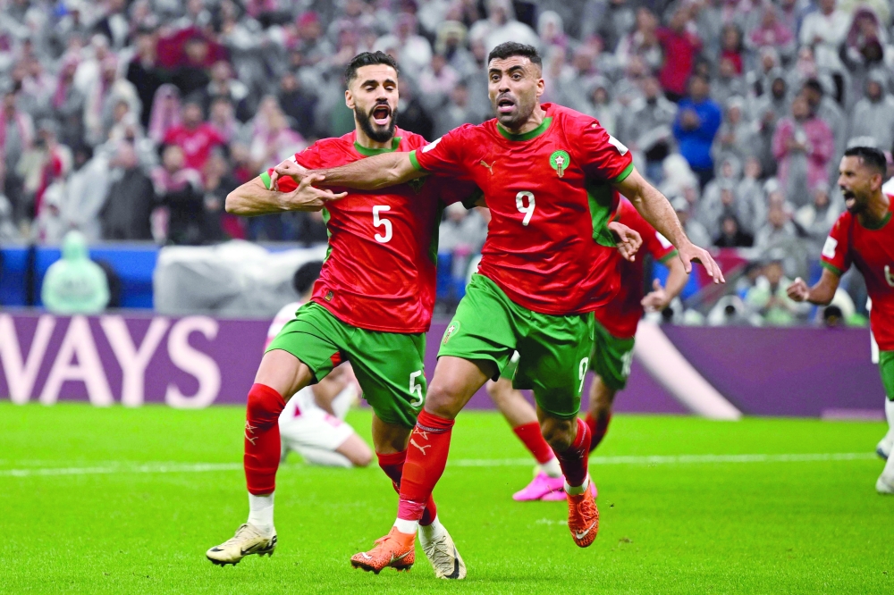 Morocco's forward #9 Abderrazzaq Hamed Allah celebrates scoring his team's seccond goal during the FIFA Arab Cup 2025 final football match between Jordan and Morocco at the Lusail Stadium  Stadium, in Lusail on December 18, 2025. (Photo by Mahmud HAMS / AFP)
