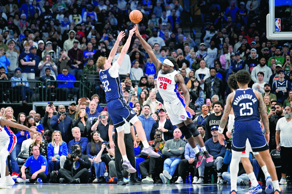 Dallas Mavericks forward Cooper Flagg (32) makes a jump shot over Detroit Pistons forward Isaiah Stewart (28) to take the lead during the fourth quarter at the American Airlines Center. — Imagn Images