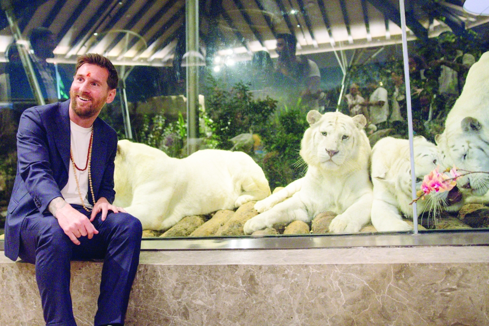 Argentina and Inter Miami's Lionel Messi poses next to white tigers in an enclosure at Vantara animal rescue and rehabilitation centre in Jamnagar, Gujarat, India, December 15, 2025. Vantara/Handout via REUTERS