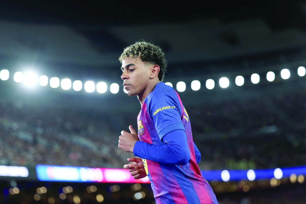 Barcelona's Spanish forward #10 Lamine Yamal is pictured during the Spanish league football match between FC Barcelona and CA Osasuna at Camp Nou Stadium in Barcelona on December 13, 2025. (Photo by Josep LAGO / AFP)
