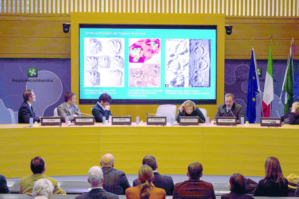 Photos on a screen show dinosaur tracks discovered in Italy's Stelvio National Park. — AFP