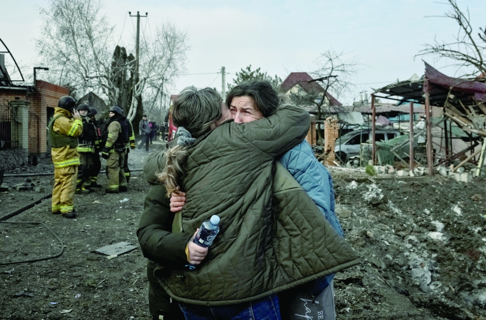 Residents react at the site of a Russian air strike, in Zaporizhzhia, Ukraine. — Reuters 