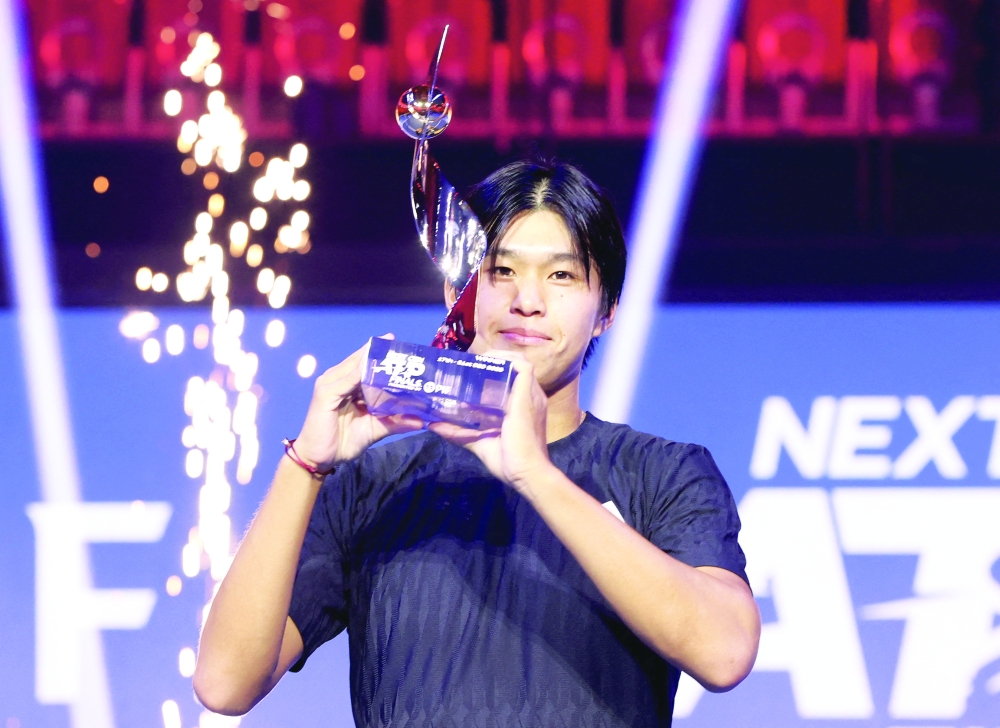 Learner Tien of the US celebrates with the trophy after winning the final match against Belgium's Alexander Blockx. — Reuters