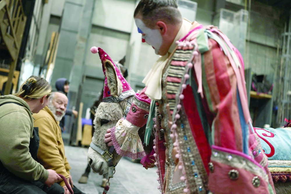 Actor Gregory Warren pats Wanda the donkey as they wait backstage ahead of a presentation of "La Boheme" at the MET Opera in New York City. — AFP
