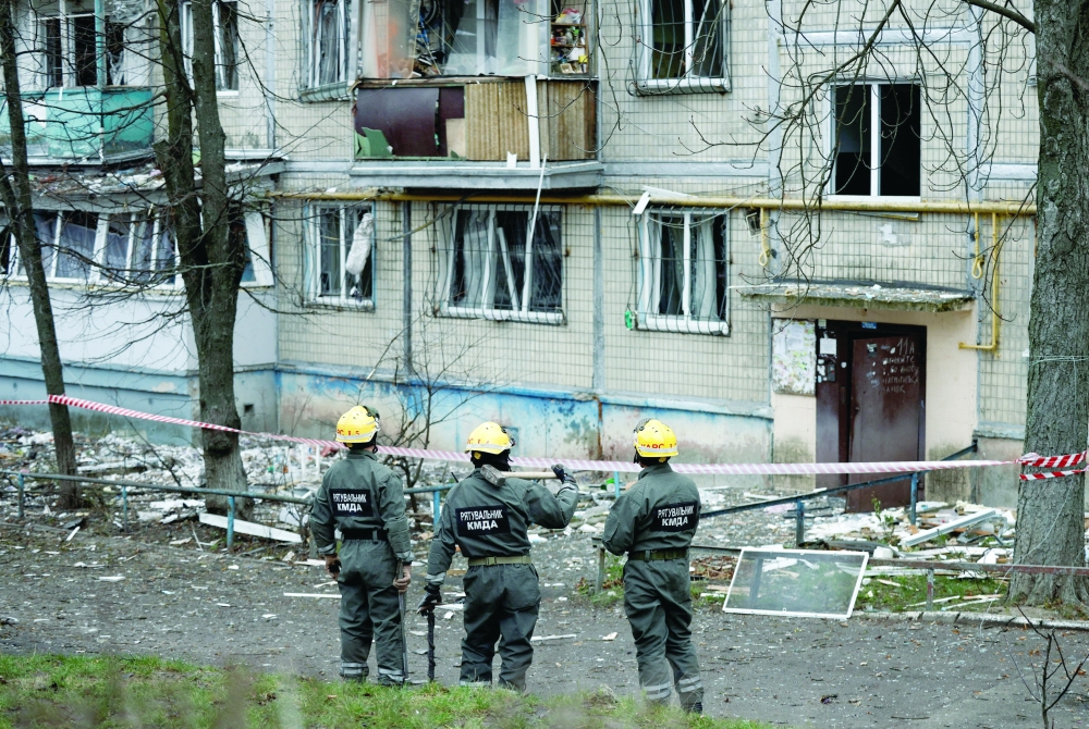 Emergency responders work at the site of a Russian drone strike, in Kyiv. — Reuters