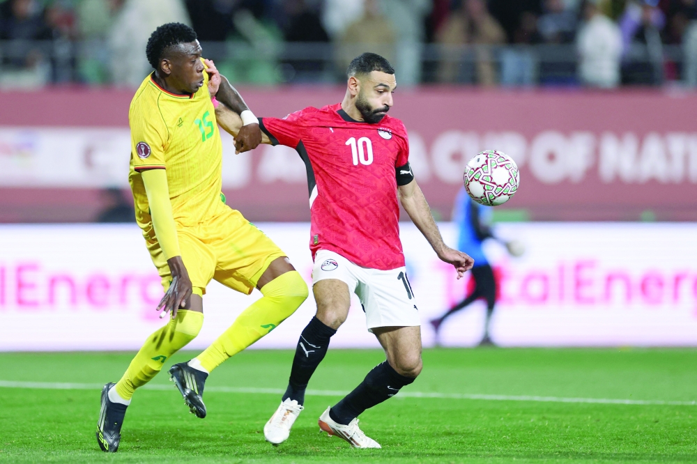Zimbabwe's defender #15 Teenage Hadebe and Egypt's forward #10 Mohamed Salah compete during the Africa Cup of Nations (CAN) group B football match. — AFP 