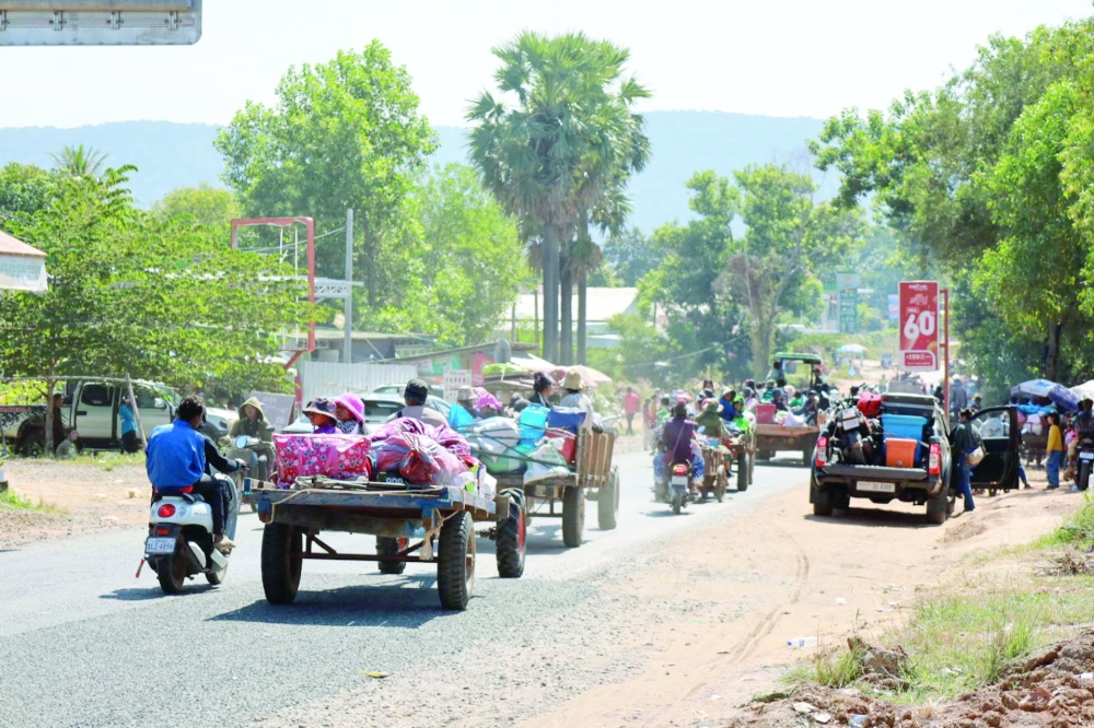 People make their way between Thailand and Cambodia border. — Reuters