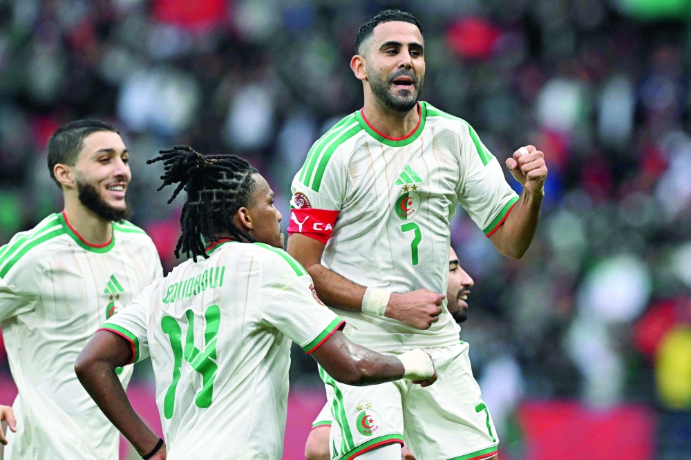 Algeria's forward #7 Riyad Mahrez (R) celebrates scoring the team's second goal during the Africa Cup of Nations (CAN) Group E football match between Algeria and Sudan at Moulay Hassan Stadium in Rabat on December 24, 2025.   (Photo by Gabriel BOUYS / AFP)

