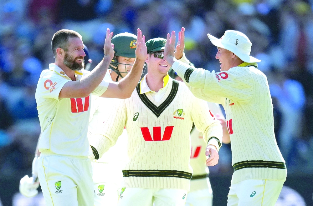 Cricket - The Ashes - Australia v England - Fourth Test - MCG, Melbourne, Australia - December 26, 2025 Australia's Michael Neser celebrates taking the wicket of England's Brydon Carse with teammates REUTERS/Asanka Brendon Ratnayake