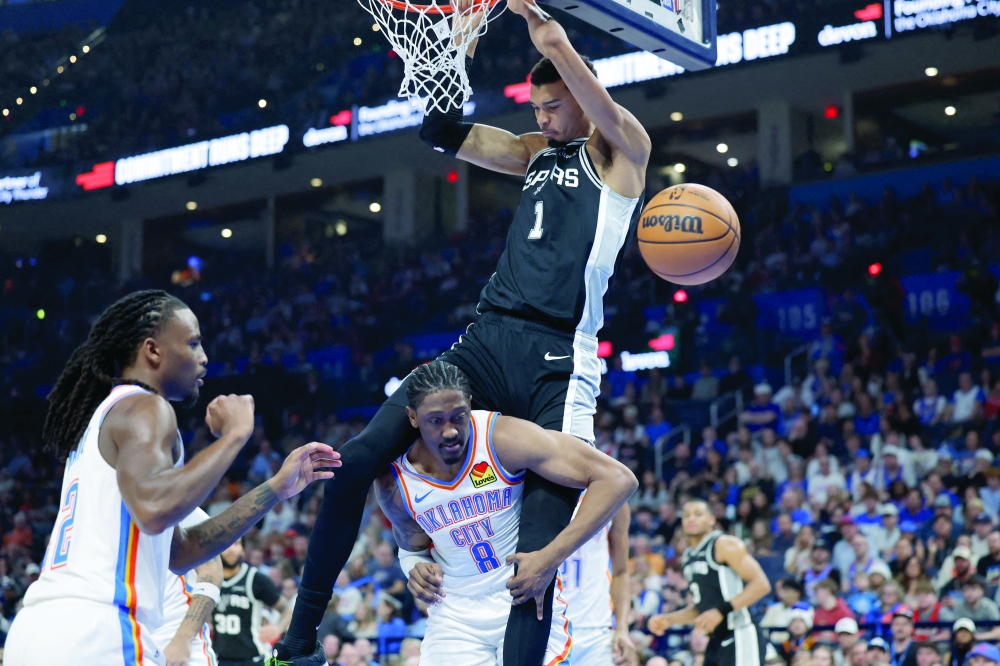 San Antonio Spurs forward Victor Wembanyama (1) dunks over Oklahoma City Thunder guard Jalen Williams (8) during the second quarter at Paycom Center. Mandatory Credit: Alonzo Adams-Imagn Images