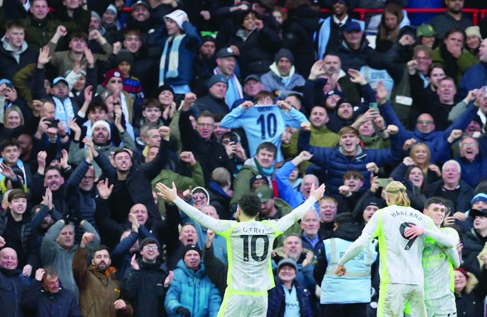 Manchester City's Rayan Cherki celebrates scoring their second goal with Erling Haaland and Phil Foden. — Reuters 